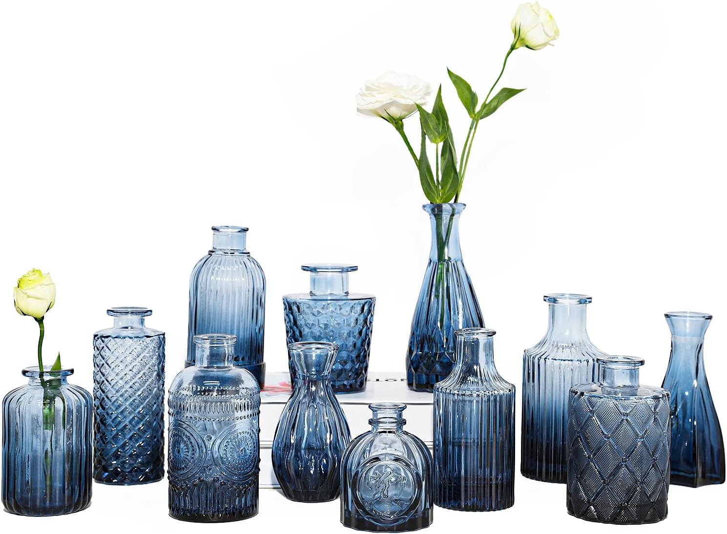 Set of 12 vintage etched blue glass bud vases arranged as decorative centerpieces