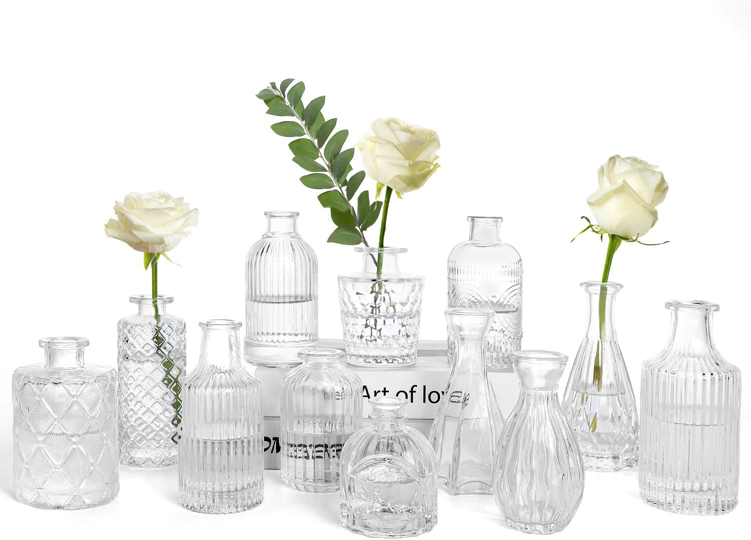 Set of 12 vintage etched clear glass bud vases arranged as decorative centerpieces
